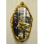 A decorative gilt oval looking glass