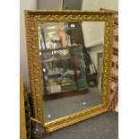 A large contemporary decorative gilt looking glass