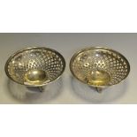 A pair of George V silver circular pierced sweetmeat dishes, outswept feet,