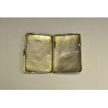 A George V silver cigarette or visiting card case, planished overall,