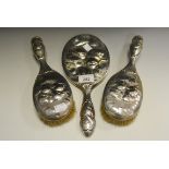 Silver - a Reynolds angels three piece embossed vanity set, William Comyns and Sons,