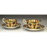 A pair of Royal Crown Derby 1128 pattern cups and saucers