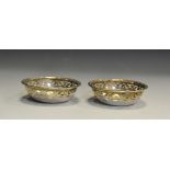 A pair of George V silver circular sweetmeat dishes, Walker & Hall,