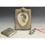 A square silver compact, Birmingham 1938; a child's silver rattle Birmingham 1965, a silver frame,