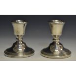 A pair of miniature candlesticks, dated 1968,