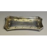 A George V silver incurved canted rectangular trinket tray,