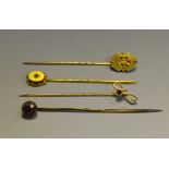 a 15ct gold stick pin; another 9ct set with Rubies and seed pearl; another 9ct;