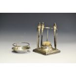 A George V silver manicure set stand, Chester 1914; an ashtray,