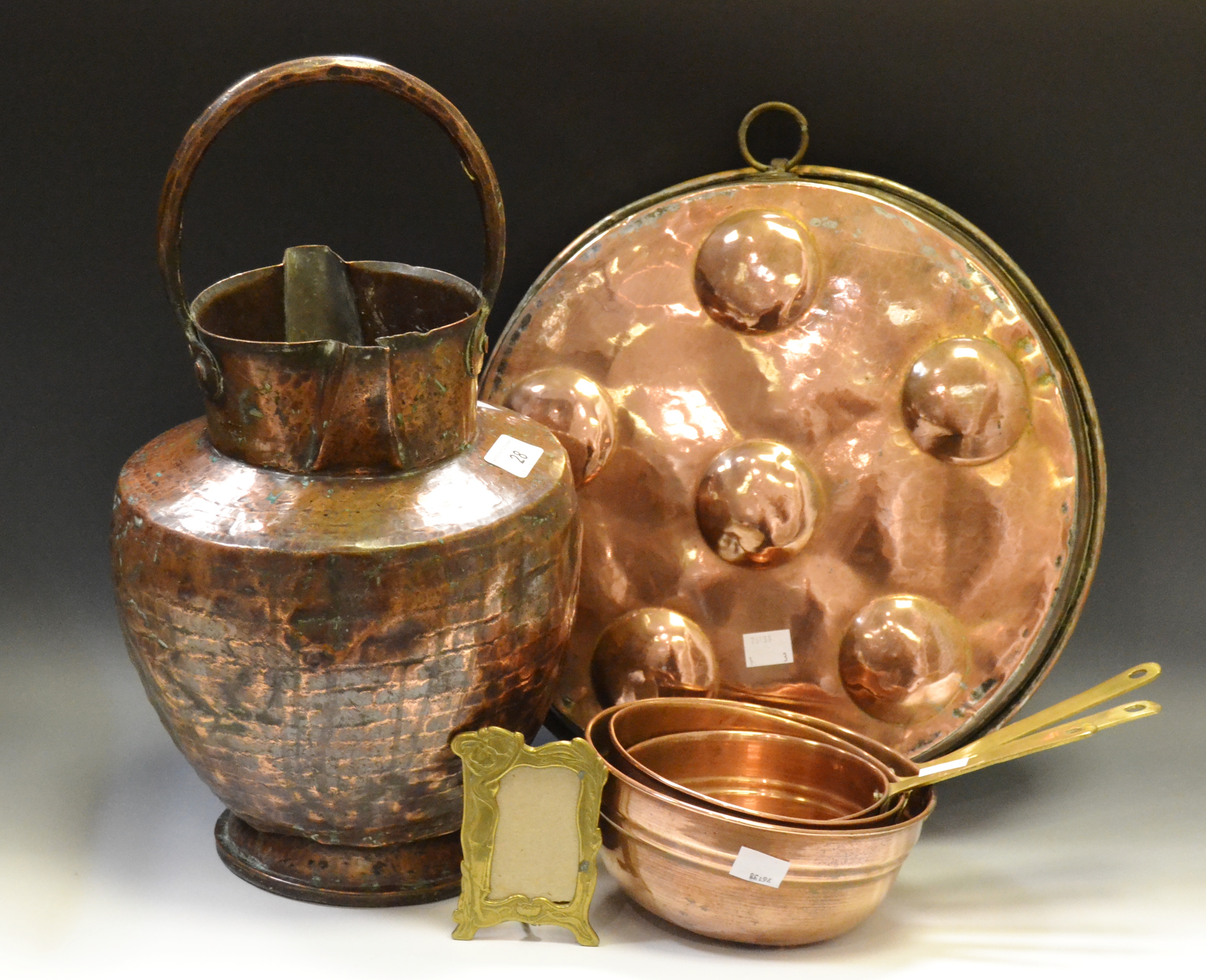 Metal Ware - an 18th century copper twin spouted ewer; a set of graduating copper pans;