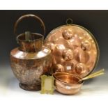 Metal Ware - an 18th century copper twin spouted ewer; a set of graduating copper pans;