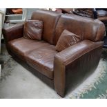 A brown leather two seater sofa