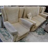 A modern three piece suite comprising three seat wingback sofa and two conforming armchairs.