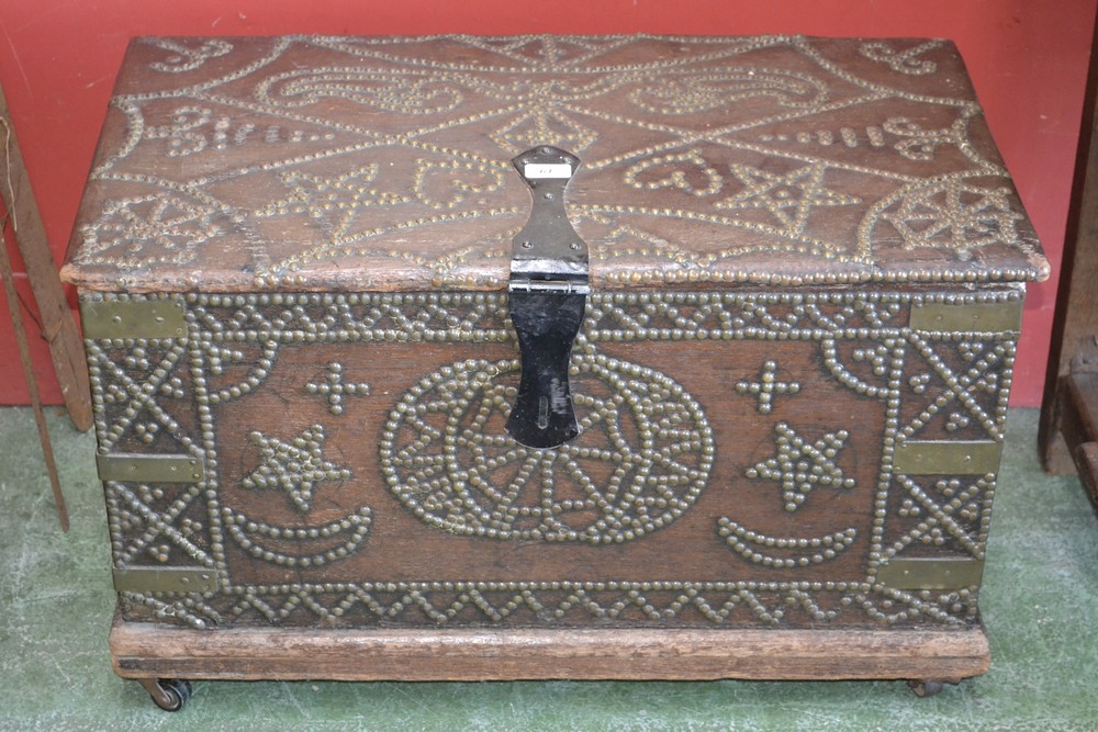 An Eastern brass studded box, iron clasps, wrought handles.