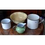 A vintage enamel bowl; two enamel mugs;