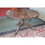 A George III low occasional table, circular top, turned column, three cabriole legs, pad feet.