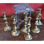 A Victorian brass trivet; a pair of 19th century brass candlesticks;