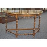 A mahogany demi-lune table, deep frieze, pierced and carved S - scroll skirt, turned legs,