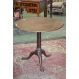 A George III oak tripod tilt-top table, circular top, canon barrel column, cabriole legs, pad feet,