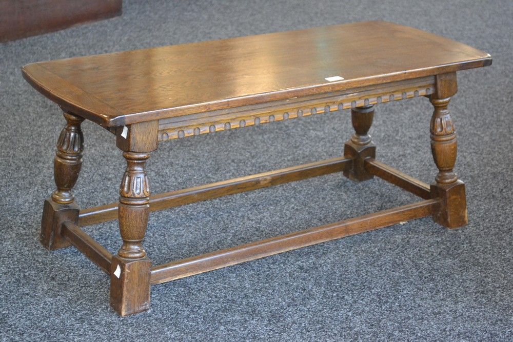 A oak coffee table, turned supports.