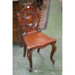 A William IV mahogany hall chair, carved cartouche shaped back, serpentine fronted wooden seat,