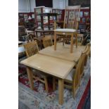 A M&S elm dining table, four lath back chairs, two carvers.