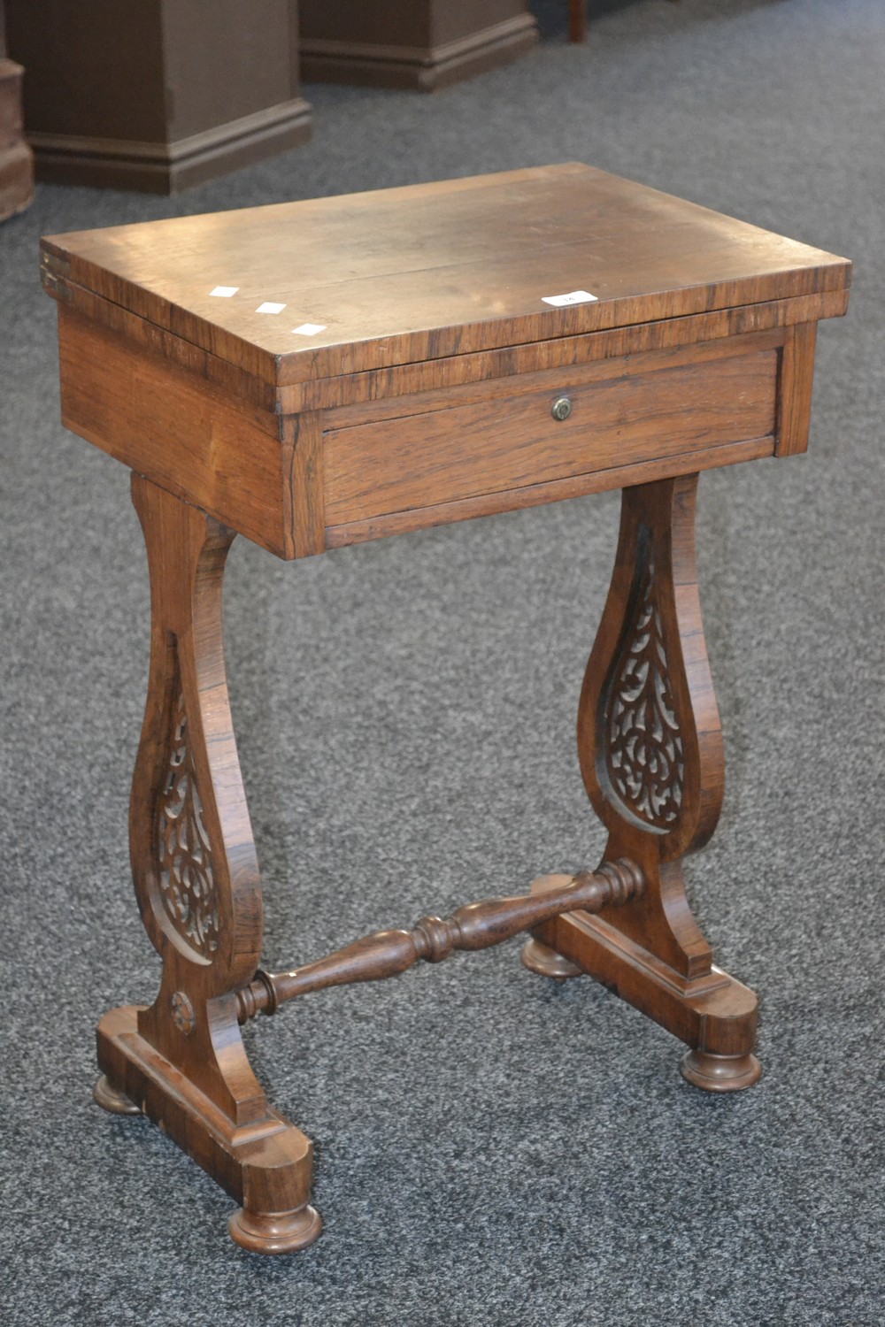 A Victorian rosewood workbox, hinged pivoting top, single drawer to frieze,