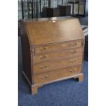 A George III oak bureau, fall front enclosing fitted interior, four graduated cockbeaded drawers,