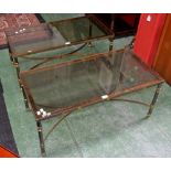 A pair of decorative glass and metal coffee tables.