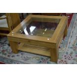 A modern elm coffee table, glass inlaid square top, undertier.