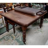 A late Victorian/Edwardian mahogany wind out dining table canted rectangular top, turned legs,