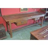 A rustic stained pine and oak country kitchen table, galleried back, plank top, two deep drawers,