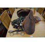 A leather saddle; a snaffle bit; bridle and reins; stirrups; etc.