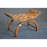 An oak X-frame stool, lattice worked leather seat.
