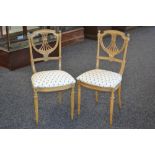 A pair of Rococo revival bedroom chairs, pierced back, fluted uprights, stuffed over seat,