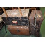 A dome topped tin travel trunk; a large wooden travel trunk;