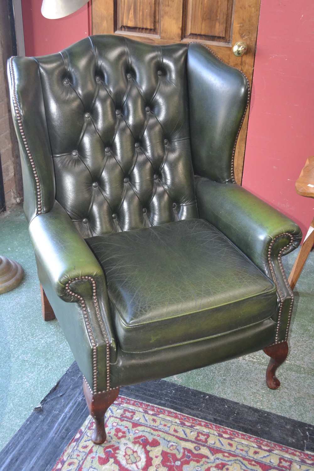 A Chesterfield wingback fireside chair.