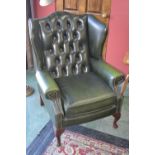 A Chesterfield wingback fireside chair.