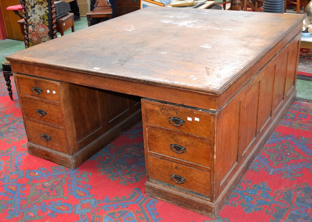 A large oak partners desk, oversailing top,