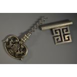 A silver-plated novelty travelling corkscrew, as a key, the handle with a coat of arms,