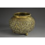 A 19th century Indian bronze censer, cast in relief with deities amongst scrolling leafy branches,