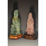A Chinese rose quartz carving, of Guanyin, she stands, serene, holding a basket of fish,