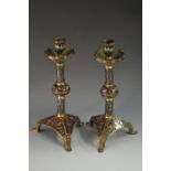 A pair of brass and cloisonne candlesticks, everted drip pans, knopped columns, triangular bases,