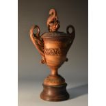 A 19th century Indian sandalwood two-handled vase and cover, stylised beast finial,