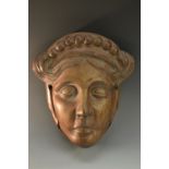 A 19th century mahogany wall boss, boldly carved as a female mask, in the Classical taste,