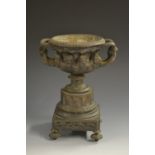 A 19th century dark patinated bronze urn, cast after the antique with bearded masks,