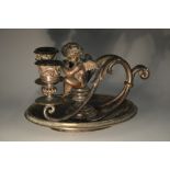 A 19th century dark patinated bronze figural two-light chamberstick,