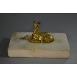 A 19th century gilt bronze mounted desk weight, cast as a recumbent deer,