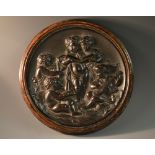 A 19th century bois durci type composition roundel, of putti allegorical of The Arts,