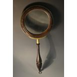 A George III brass bound mahogany gallery glass or connoisseur's lens, turned border and handle,