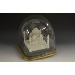 A 19th century Indian alabaster model, of the Taj Mahal, painted detail to facade, glass dome,